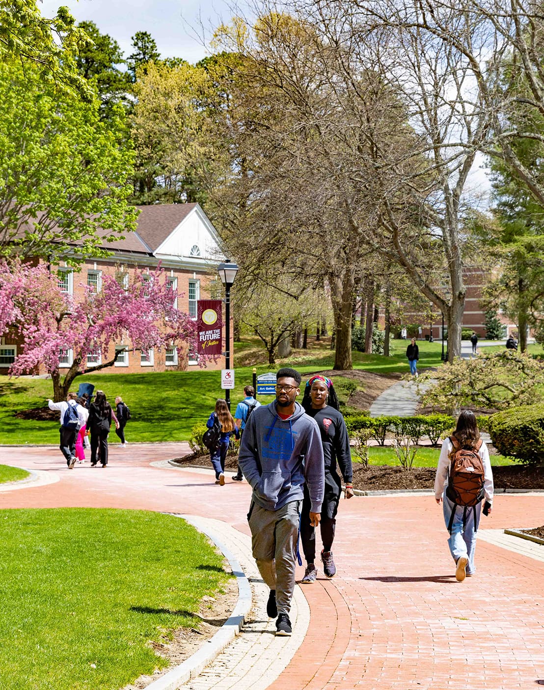 Students walking through campus on beautiful spring day