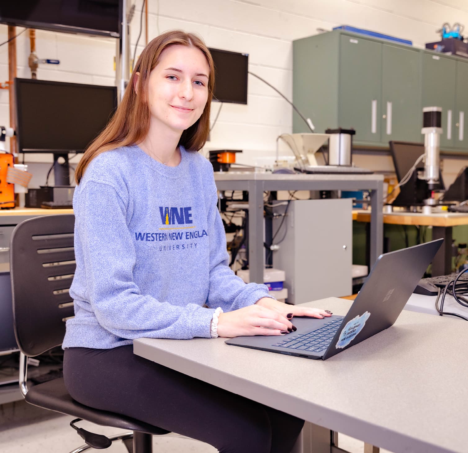 Female student sitting at laptop