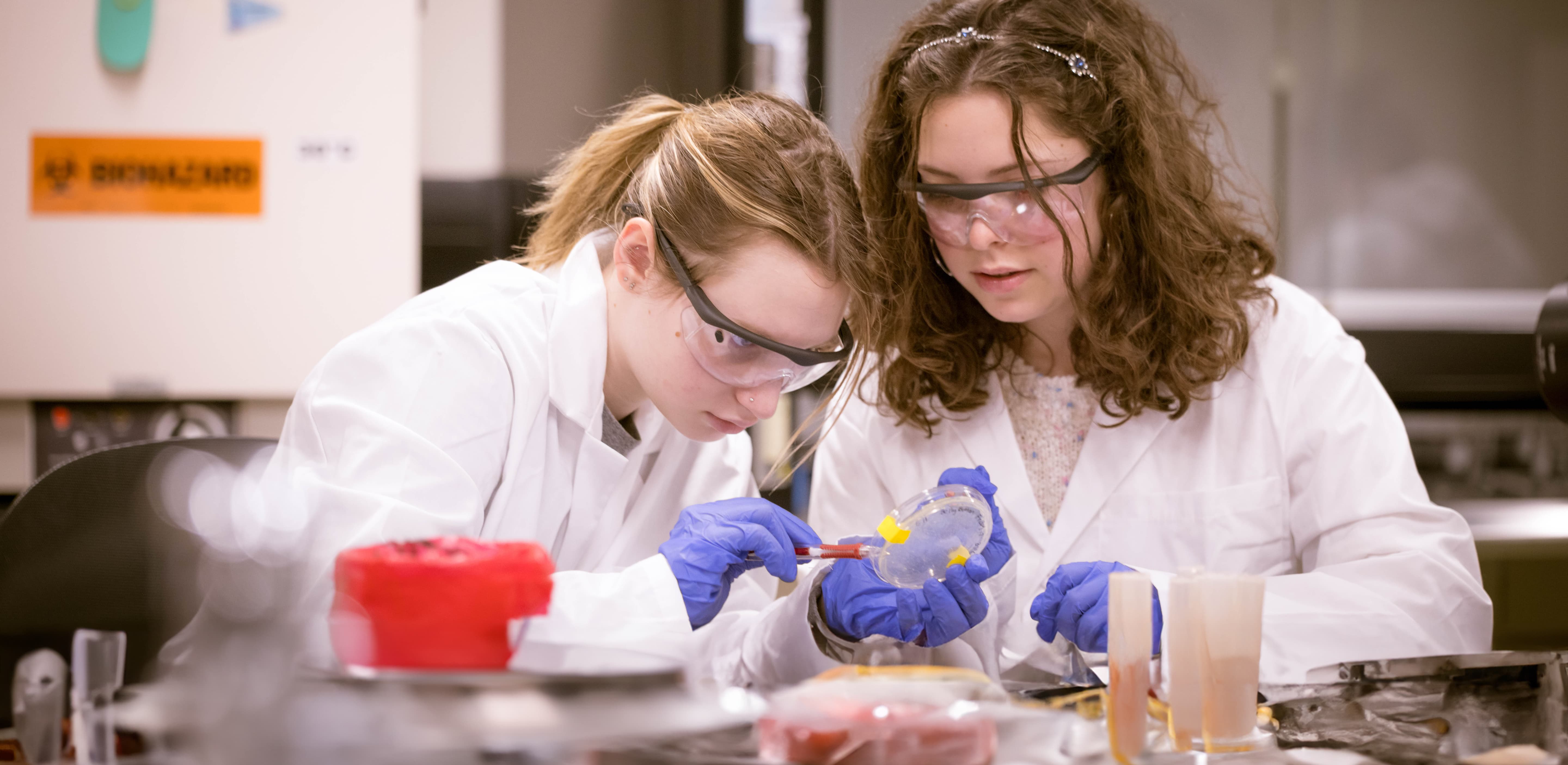 Two female students working in a lab.