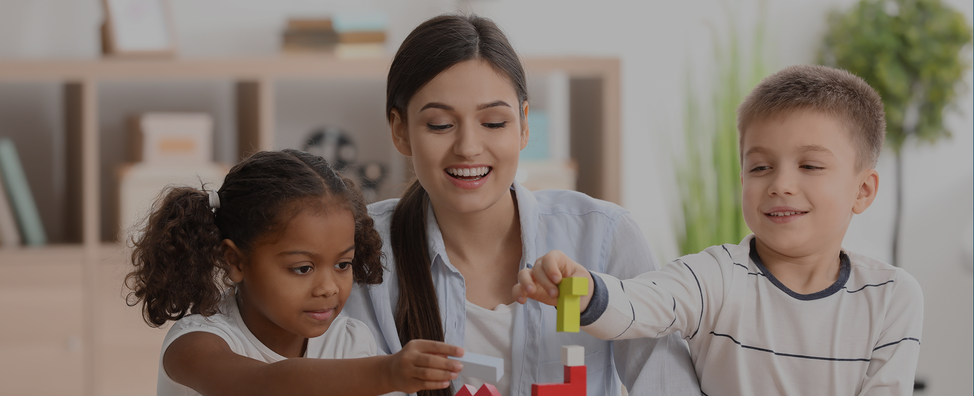 Female working with two young children