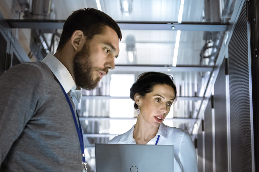 Man and woman standing with laptop