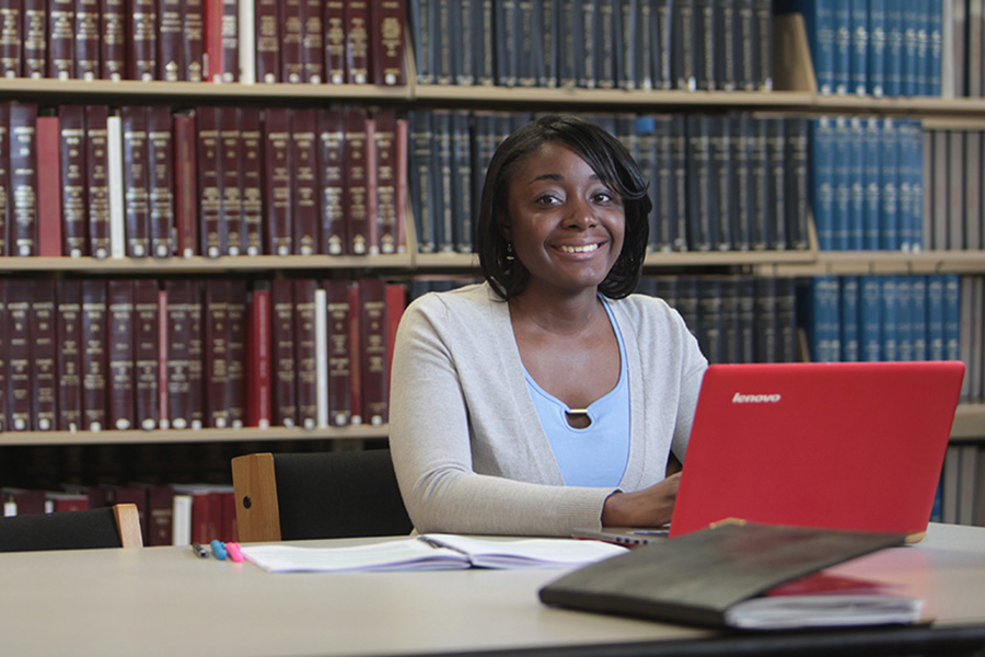 Female student sitting at laptop