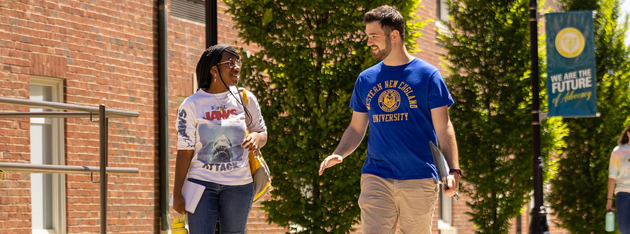 Two students walking on campus