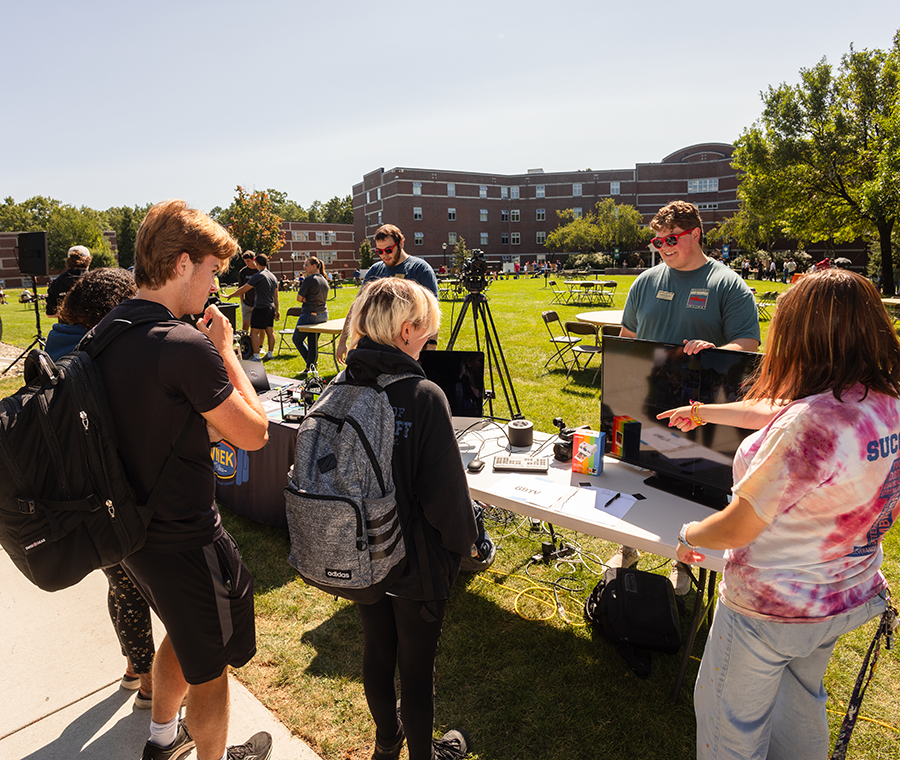 Students at involvement fair table