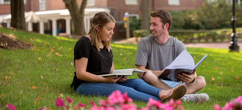 Students sitting on campus doing homework