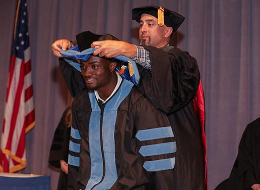 Pharmacy student being hooded at ceremony