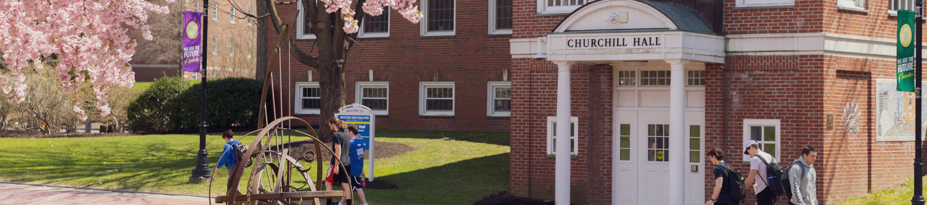 Three students walking through campus