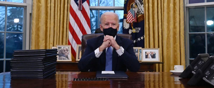 President Biden at his desk in the oval office.