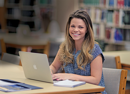 Female student sitting in front of laptop