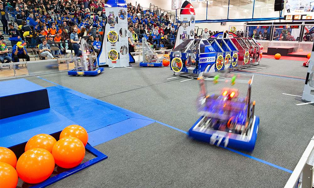 Robots competing in FIRST Robotics challenge at WNE
