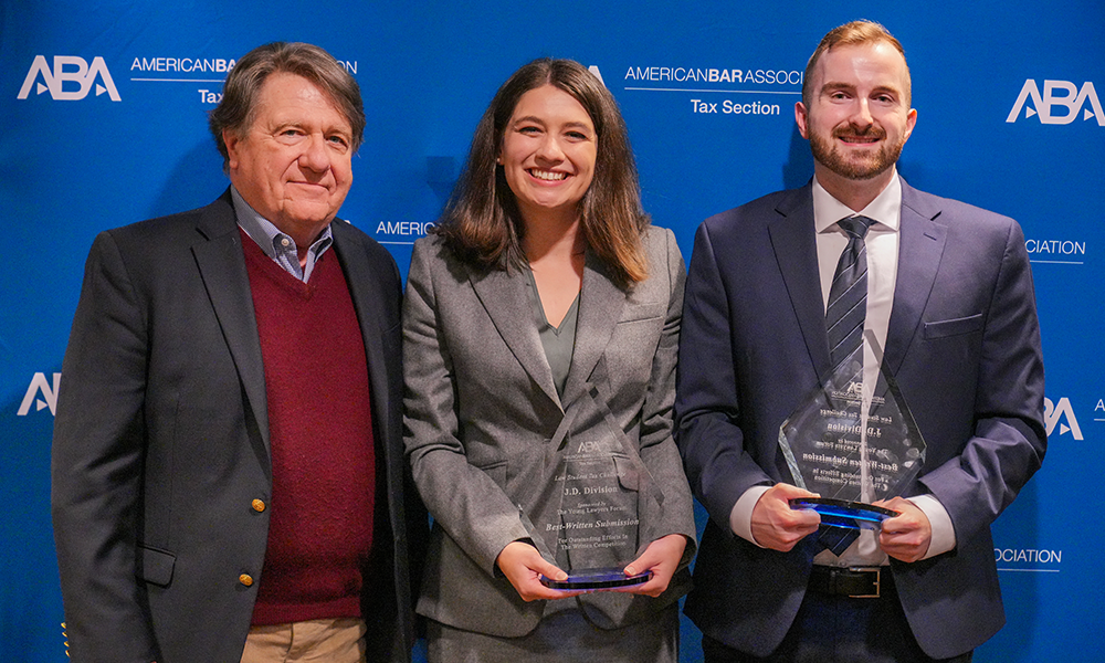 (L to R:) Faculty mentor Professor Fred Royal joins law student winners, Joy Vincenzo and Brendan Morrison, to celebrate their recent victory at the ABA Tax Challenge Competition. 