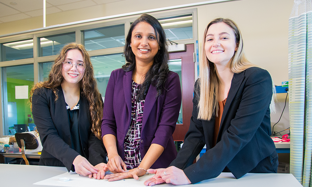 2024 KEEN Rising Star Award winner Dr. Devina Jaiswal working with students in the lab.