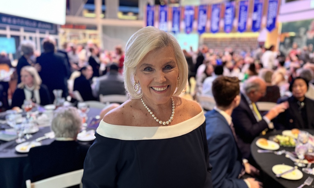 Brenda Garton in foreground in front of tables at the Basketball Hall of Fame.