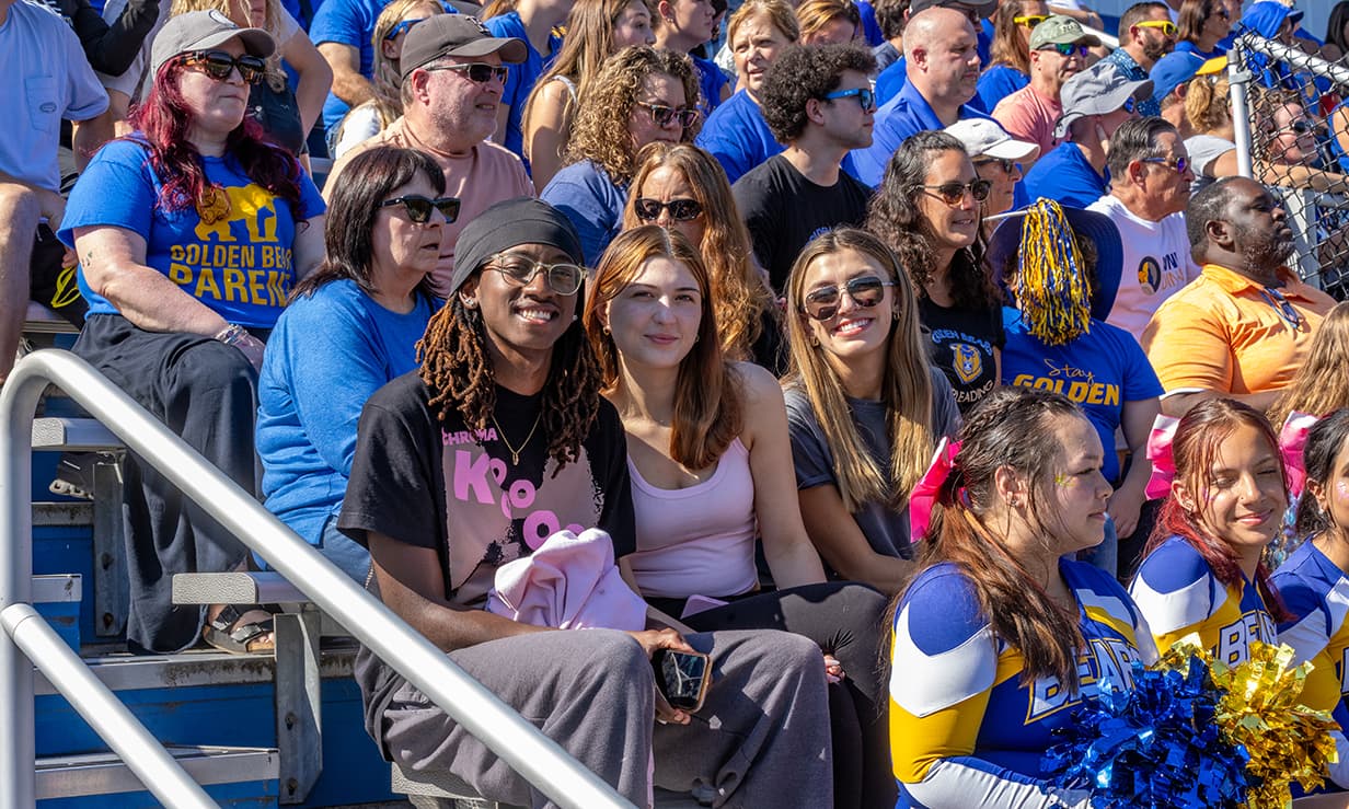 Students in the stands at a football game