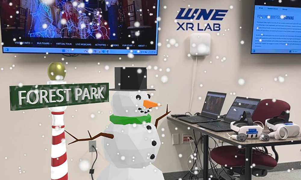 A digital snowman in falling snow with a sign pointing toward Forest Park are featured over an image of the XR lab.