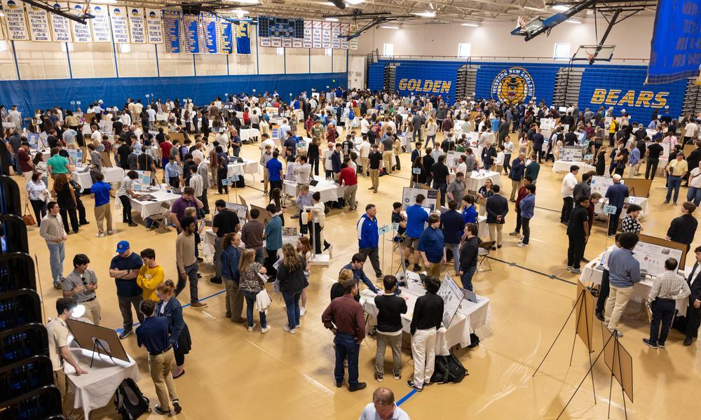 Wide-angle photograph of the 2026 Emerging Engineers Expo in WNE's HLC gym.