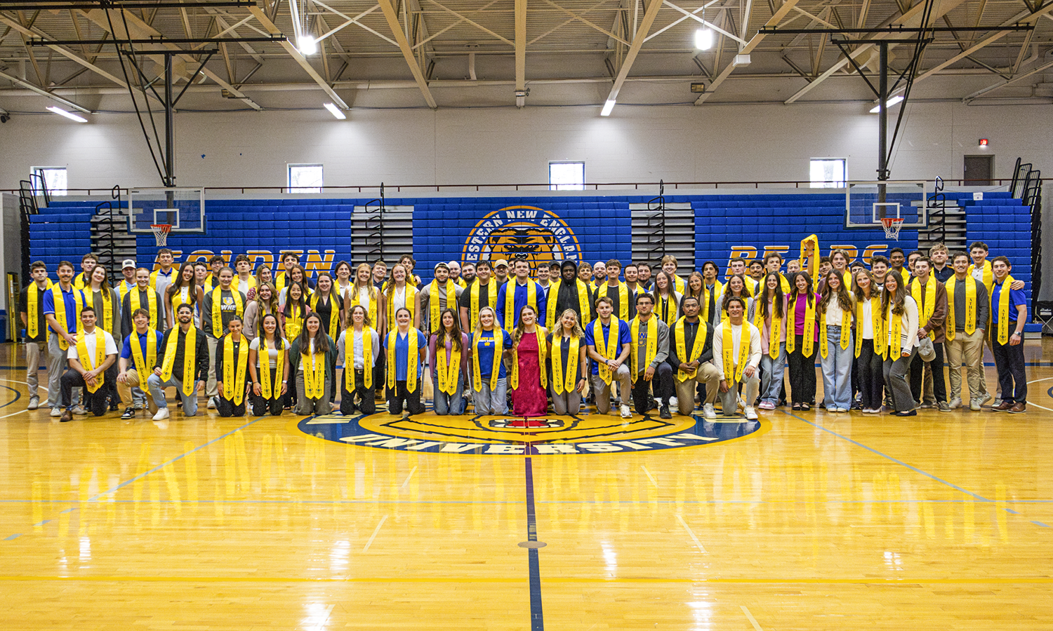 Group photo of 50 WNE student athletes in gym.