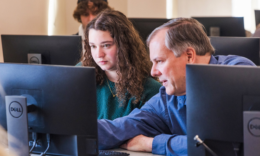 Faculty member and student in front of computer.