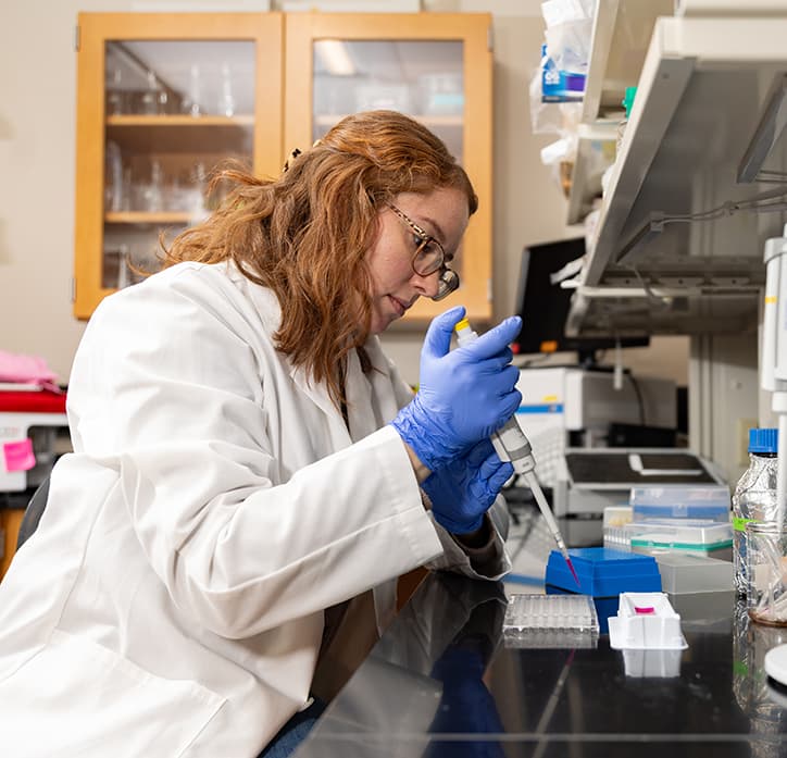 woman in meeting standing at a white board