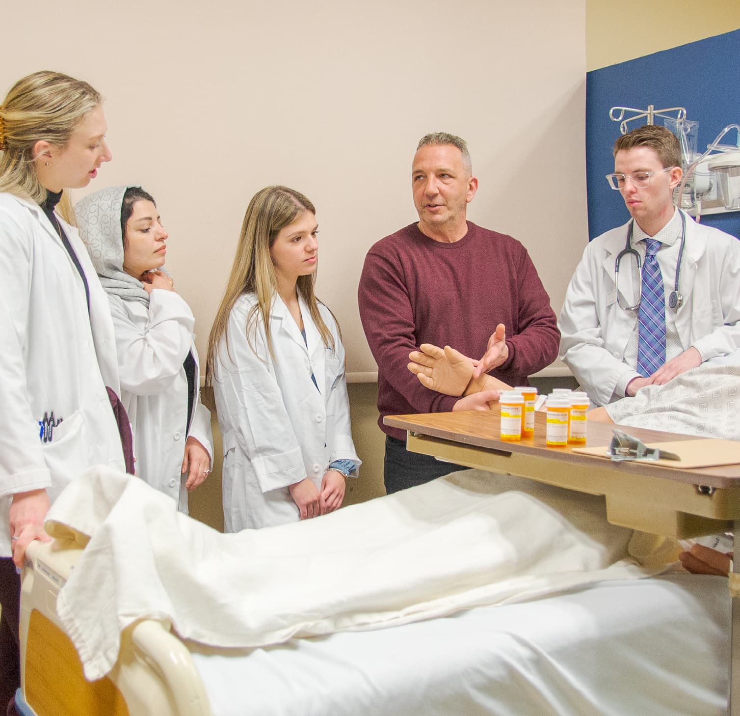 Students with professor in hospital setting