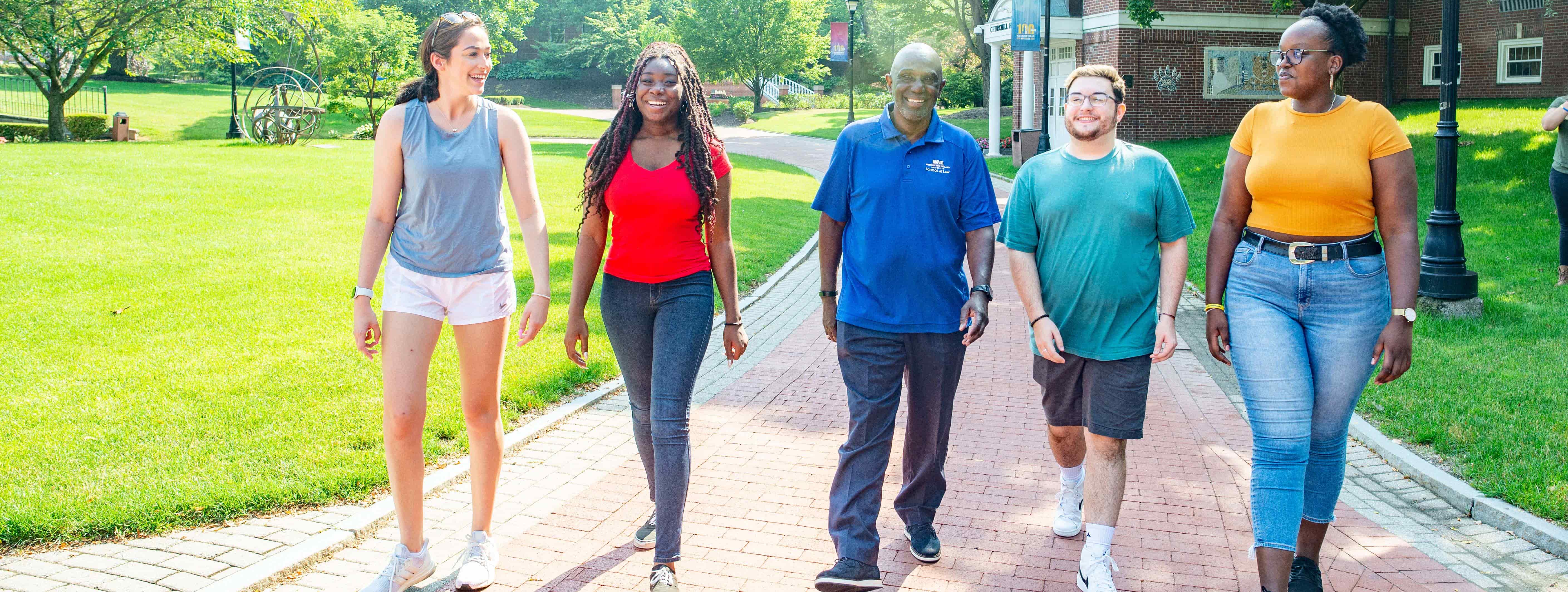 Dr. Johnson walking with students on campus