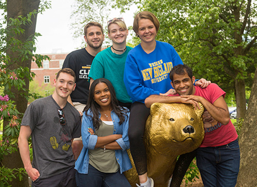 Students with golden bear statue